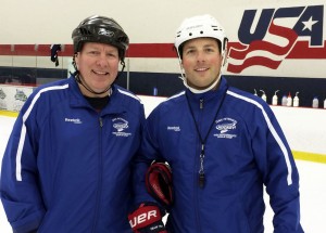 L-r: Coach Carroll with Kevin Reiter at Minnesota Hockey Goalie Camp.